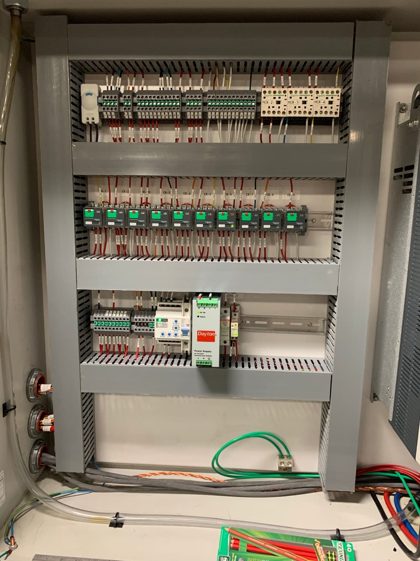 Completed compact control panel with labeled relays, contactors, and DIN-rail power supply